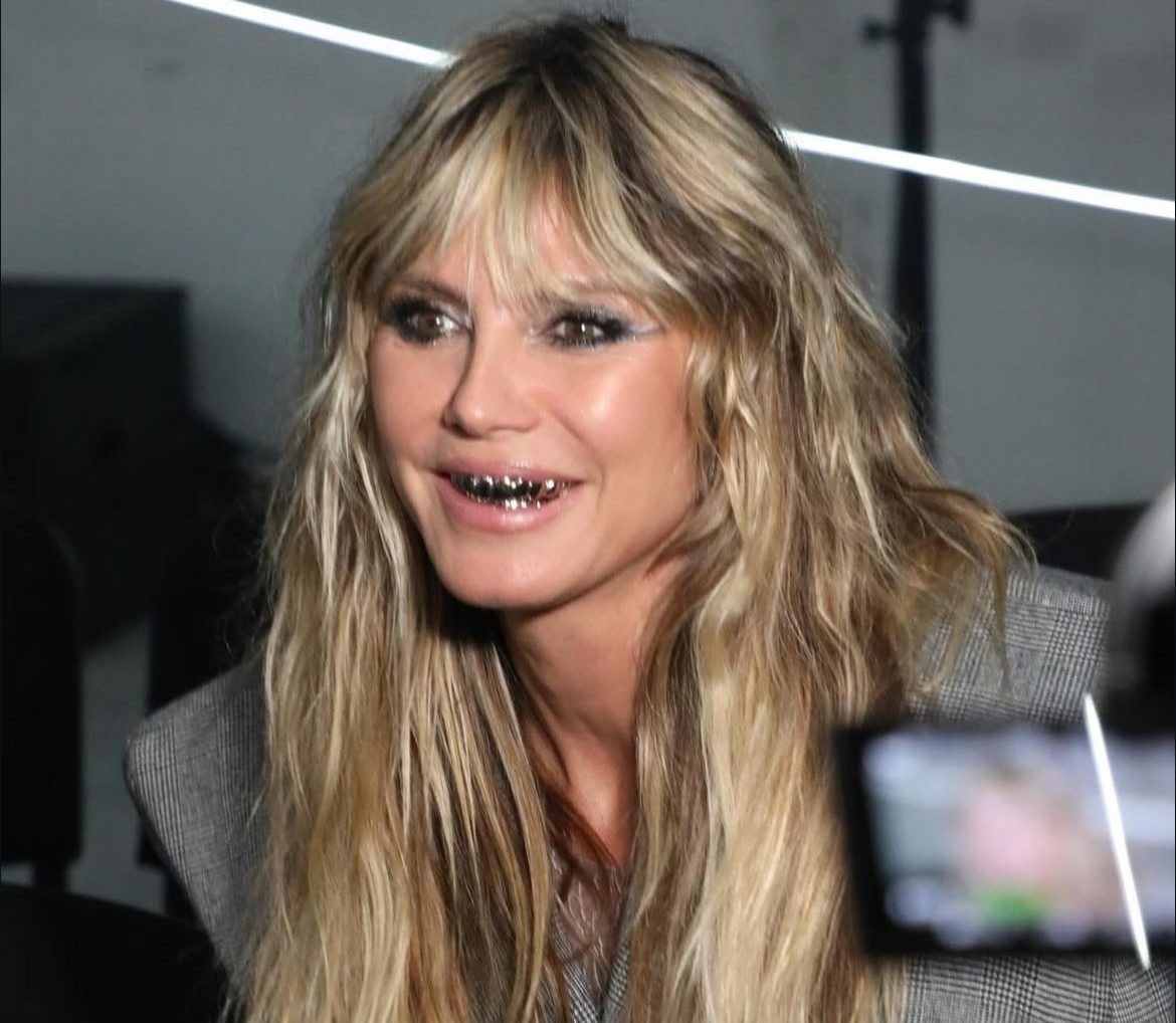 Heidi Klum wearing Vetements with metallic grillz and an edgy high-fashion look.