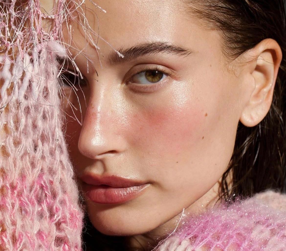 Hailey Bieber in a Clean Girl Aesthetic look with sleek hair, natural makeup, and minimalist styling.