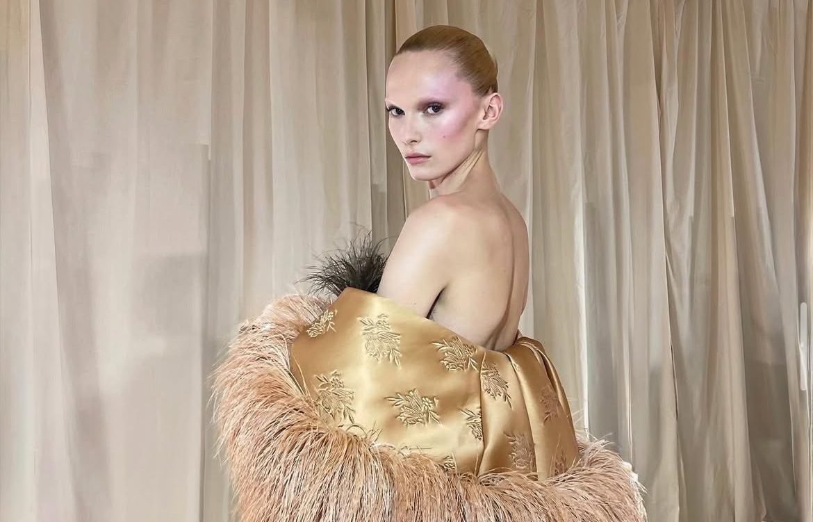 Alex Consani in a Clean Girl–inspired beauty look with sleek hair, soft glow, and minimalist styling